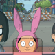 Tina, Louise, and Gene Belcher stare into a ticket window.